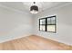 Well-lit bedroom with light wood floors, white walls, and a dark metal light fixture at 199 Heartland Dr # 10, Rock Hill, SC 29732