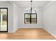 Bright dining room featuring wood floors, a modern chandelier, and view to outdoor deck at 199 Heartland Dr # 10, Rock Hill, SC 29732