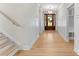 Inviting entryway with light wood floors, wood door, white walls, and a staircase at 199 Heartland Dr # 10, Rock Hill, SC 29732