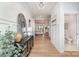 Elegant entryway with chandelier, console table with decor, and view into the living and dining areas at 199 Heartland Dr # 10, Rock Hill, SC 29732