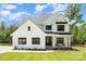 Stunning two-story modern farmhouse with white siding, black trim, and rocking chair front porch at 199 Heartland Dr # 10, Rock Hill, SC 29732