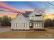 Charming two-story white home with a well-manicured lawn and beautiful sunset at 199 Heartland Dr # 10, Rock Hill, SC 29732