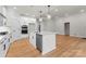 Kitchen island featuring stainless appliances, custom cabinets and light wood flooring at 199 Heartland Dr # 10, Rock Hill, SC 29732