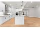 Open concept kitchen with a center island, white cabinets, stainless appliances, and wood floors at 199 Heartland Dr # 10, Rock Hill, SC 29732