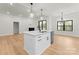 An open kitchen floor plan, an island with lighting and a gas burning fireplace at 199 Heartland Dr # 10, Rock Hill, SC 29732