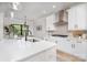 Bright, white kitchen with stainless steel range hood, modern fixtures, and an open view into the dining area at 199 Heartland Dr # 10, Rock Hill, SC 29732