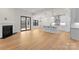Open-concept living room with fireplace, wood floors, and white kitchen in the background at 199 Heartland Dr # 10, Rock Hill, SC 29732
