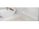 Luxurious soaking tub adjacent to the window creates a spa-like experience with white tile flooring at 199 Heartland Dr # 10, Rock Hill, SC 29732