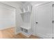 Hall tree with seating and storage in a mudroom area, featuring white trim and light wood floors at 199 Heartland Dr # 10, Rock Hill, SC 29732