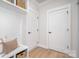 Well-organized mudroom features built-in storage, bench seating and neutral decor with wood floors at 199 Heartland Dr # 10, Rock Hill, SC 29732