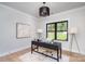 Bright office space with a modern desk, artwork, and a view of the front yard from the window at 199 Heartland Dr # 10, Rock Hill, SC 29732