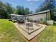 Backyard with a fire pit area, hot tub, patio, and a well-maintained lawn at 3470 Robinson Rd, Newton, NC 28658