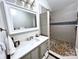 Updated bathroom with neutral gray cabinet and a pebble stone shower floor at 3470 Robinson Rd, Newton, NC 28658