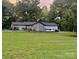 Exterior view of a home with a large yard and a mix of trees and open green space at 3470 Robinson Rd, Newton, NC 28658