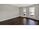 Empty room with hardwood floors, neutral paint, and bright windows at 529 Graham St # 1F, Charlotte, NC 28202