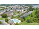 Aerial view of a neighborhood featuring a pool, pond, and townhouse exteriors at 9341 Lenox Pointe Dr, Charlotte, NC 28273