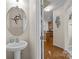 Bathroom featuring a pedestal sink and stylish decor elements at 9341 Lenox Pointe Dr, Charlotte, NC 28273
