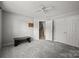 Spacious bedroom with fan, neutral paint, plush carpeting, and closet at 9341 Lenox Pointe Dr, Charlotte, NC 28273