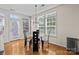 Bright dining area featuring hardwood floors, elegant chandelier, and plenty of natural light at 9341 Lenox Pointe Dr, Charlotte, NC 28273