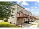 Exterior view of a multi-story townhouse with a private deck over a garage at 9341 Lenox Pointe Dr, Charlotte, NC 28273