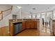 Kitchen with breakfast bar featuring stainless steel appliances, granite countertops, and hardwood floors at 9341 Lenox Pointe Dr, Charlotte, NC 28273