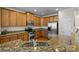 Modern kitchen with stainless steel appliances, granite countertops, and ample cabinet space at 9341 Lenox Pointe Dr, Charlotte, NC 28273