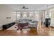Sun-filled living room showcasing hardwood floors, modern decor, and multiple windows at 9341 Lenox Pointe Dr, Charlotte, NC 28273