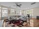 Spacious living room with a large sectional sofa, ceiling fan, and beautiful area rug at 9341 Lenox Pointe Dr, Charlotte, NC 28273