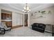 Cozy living room with stylish shelving, a modern chandelier, and comfortable seating at 9341 Lenox Pointe Dr, Charlotte, NC 28273