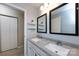 Bathroom features a double vanity with a granite countertop and decorative mirrors at 430 Queens Rd # 712, Charlotte, NC 28207