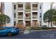 Exterior view of a condo building with multiple levels and a blue car parked nearby at 430 Queens Rd # 712, Charlotte, NC 28207