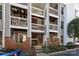 Three-story condominium featuring private balconies with hanging plants at 430 Queens Rd # 712, Charlotte, NC 28207