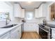 Bright kitchen featuring white cabinets, stainless steel appliances, and hardwood floors at 430 Queens Rd # 712, Charlotte, NC 28207