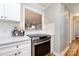 Bright kitchen featuring white cabinets, stainless steel appliances, and hardwood floors at 430 Queens Rd # 712, Charlotte, NC 28207