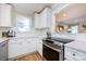 Bright kitchen featuring white cabinets, stainless steel appliances, and hardwood floors at 430 Queens Rd # 712, Charlotte, NC 28207