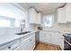 Bright kitchen featuring white cabinets, stainless steel appliances, and hardwood floors at 430 Queens Rd # 712, Charlotte, NC 28207