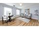 Bright living area featuring stylish seating, hardwood floors, and natural light at 430 Queens Rd # 712, Charlotte, NC 28207