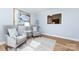 Inviting sitting area with hardwood floors, stylish chairs, and ample sunlight at 430 Queens Rd # 712, Charlotte, NC 28207