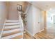 Staircase with hardwood steps and white risers, complemented by a decorative plant and neutral wall color at 430 Queens Rd # 712, Charlotte, NC 28207