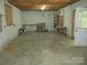 Unfinished basement with storage shelving and exterior access at 475 Cornerstone Dr, Taylorsville, NC 28681