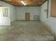 Unfinished basement with storage shelving and exterior access at 475 Cornerstone Dr, Taylorsville, NC 28681