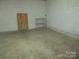 Unfinished basement with storage shelving and exterior access at 475 Cornerstone Dr, Taylorsville, NC 28681