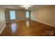 Spacious bedroom with hardwood floors and two windows at 475 Cornerstone Dr, Taylorsville, NC 28681