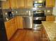 Kitchen with wood cabinets, stainless steel appliances, and hardwood floors at 475 Cornerstone Dr, Taylorsville, NC 28681