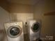 Stackable washer and dryer in a well-lit laundry room at 475 Cornerstone Dr, Taylorsville, NC 28681