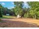 Spacious backyard with shed and wooden fence, surrounded by trees at 125 Ariel Dr, Mooresville, NC 28117