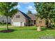 Two-story house with stone accents, attached garage, and landscaped lawn at 125 Ariel Dr, Mooresville, NC 28117