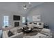 Virtually staged living room with fireplace and large windows at 125 Ariel Dr, Mooresville, NC 28117