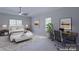 Virtually staged main bedroom with carpeted floor and ceiling fan at 125 Ariel Dr, Mooresville, NC 28117