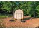 Detached storage shed in a wooded setting at 125 Ariel Dr, Mooresville, NC 28117